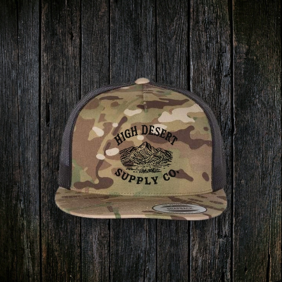 Mountains Logo Flat Brim Multicam Green/Black front - dark wood style, black-speckle defect removed below SUPPLY CO.